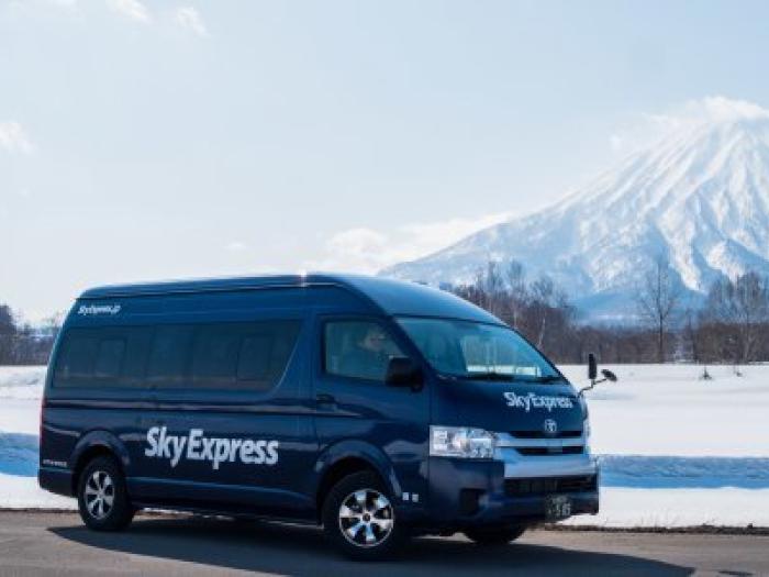 A black van with Mt Yotei in the back ground