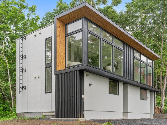 The exterior of a two story townhouse with large windows