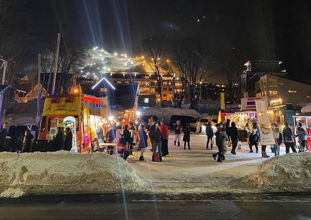 A night time photo of the bustling Hirafu food trucks  