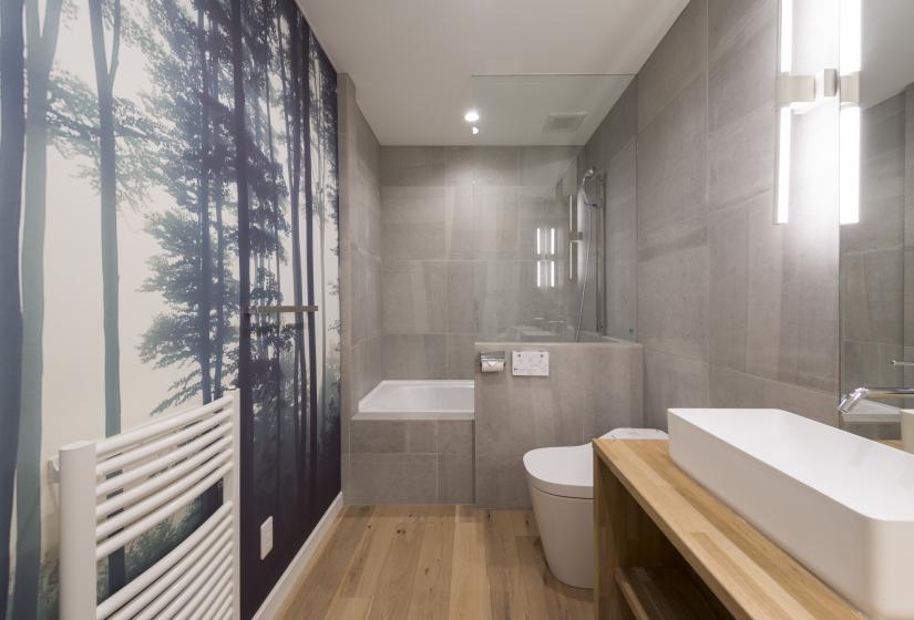 Bathroom with forest view wall paper