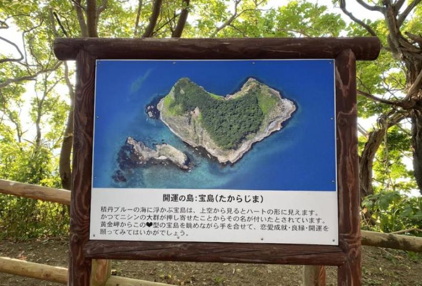 A large sign board showing a heart shaped island