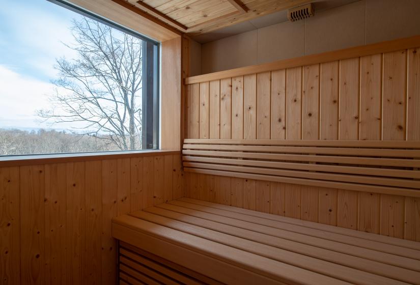 A wooden sauna with view of tree tops