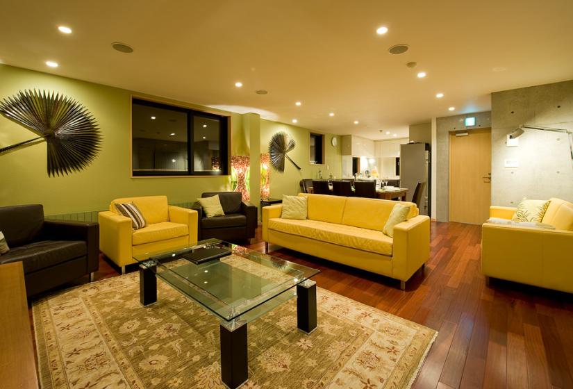 Living area with yellow sofas and light green walls