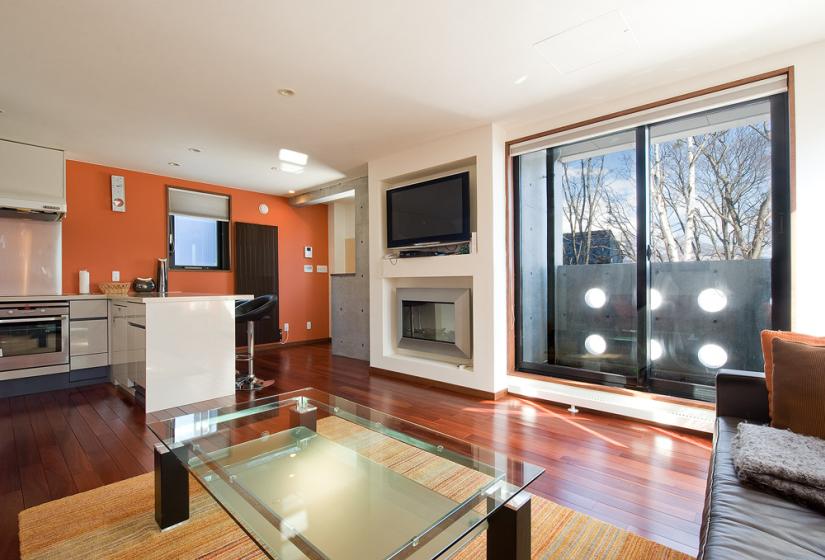 glass coffee table, fireplace, balcony, television, village view