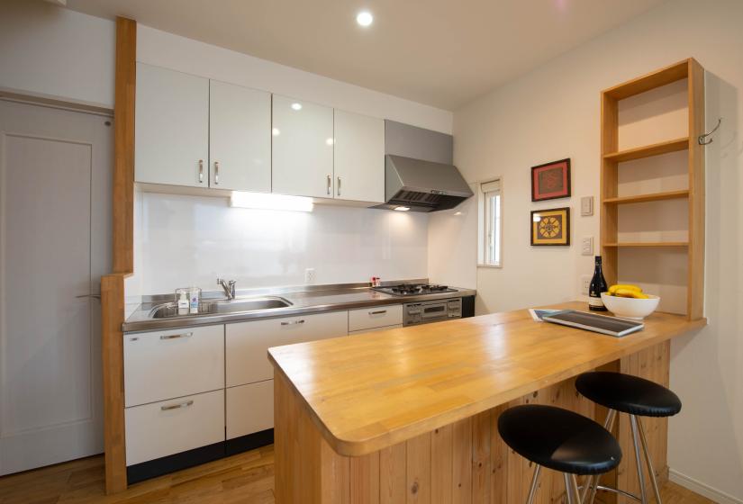 White cabinet kitchen and wooden breakfast bar