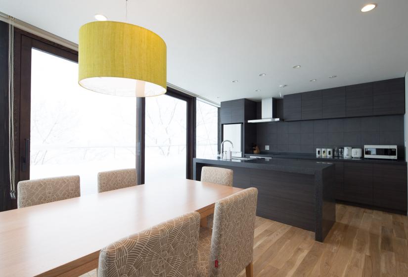 contrasting colours of dining table and kitchen