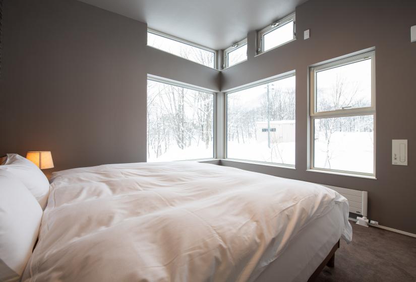 Double bed with outside snowy view