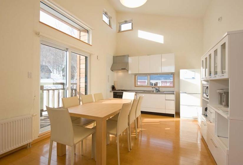 dining table for 8 people with kitchen in background