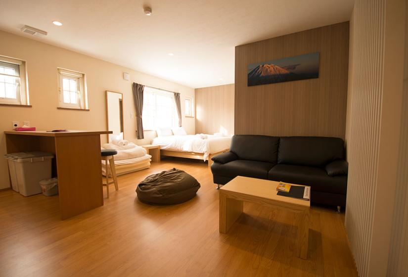 wide view of kitchen bar double bed and sofa in Snowbird Hirafu