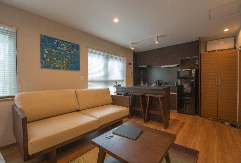 Flow Studio apartments living area with tan sofa