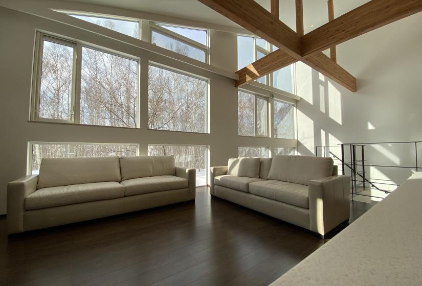 2 light coloured sofas in a large open plan room