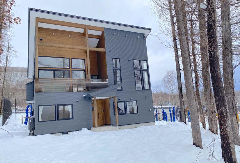 A two story home with steel and wooden siding