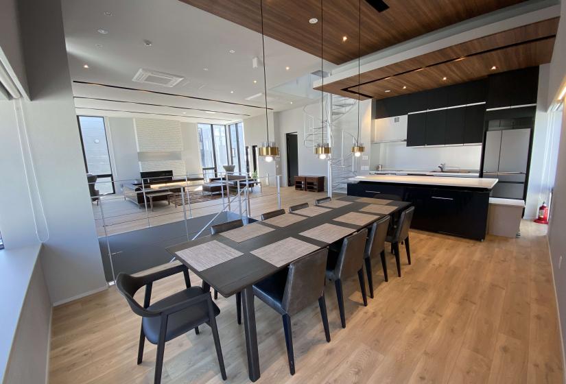 A dining table with pendant lights above