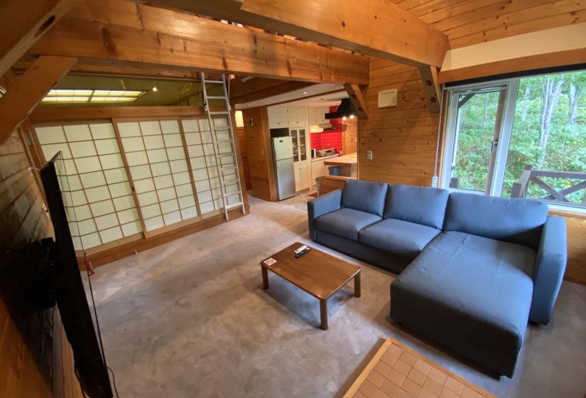 Lounge area with blue couches and shoji doors behind     