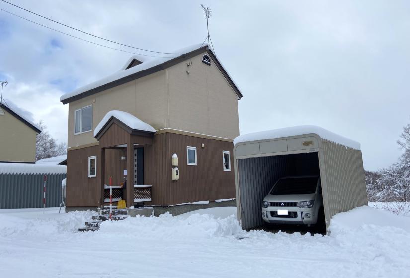 A vehicle in a garage in the snow