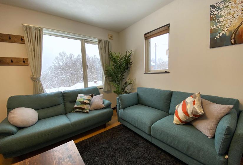 Two blue sofas with colored pillows