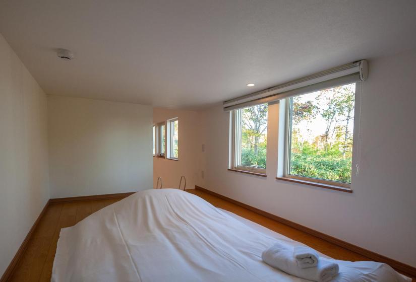 A white bed in a loft