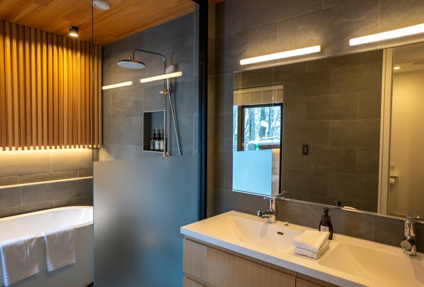 A bathrom sink and bath to the left