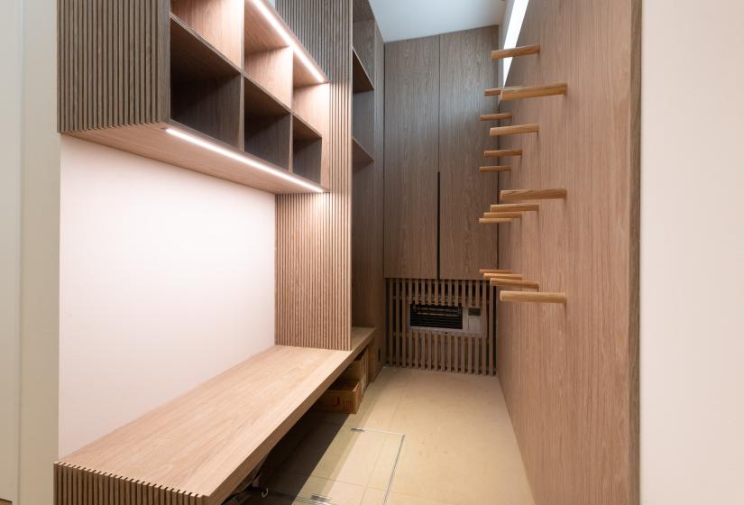 A ski drying room with pegs on the wall 