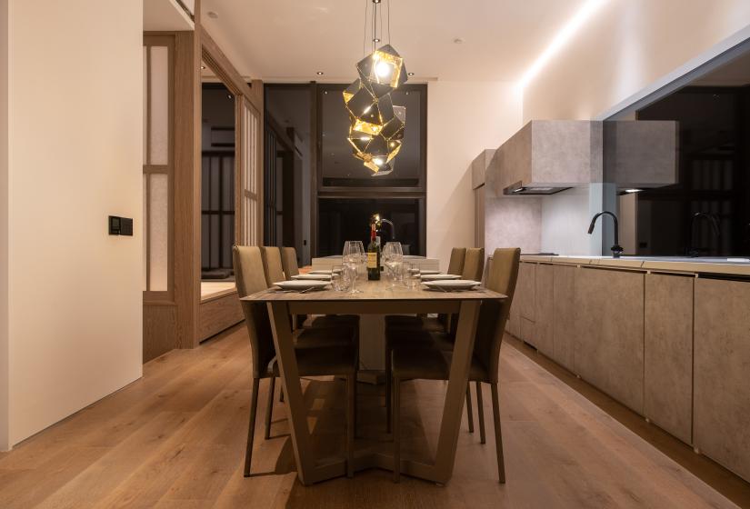 A dining table with lights above