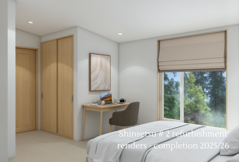 Bedroom with bed and desk behind