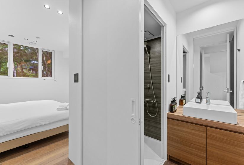 A double bed and sink to the right