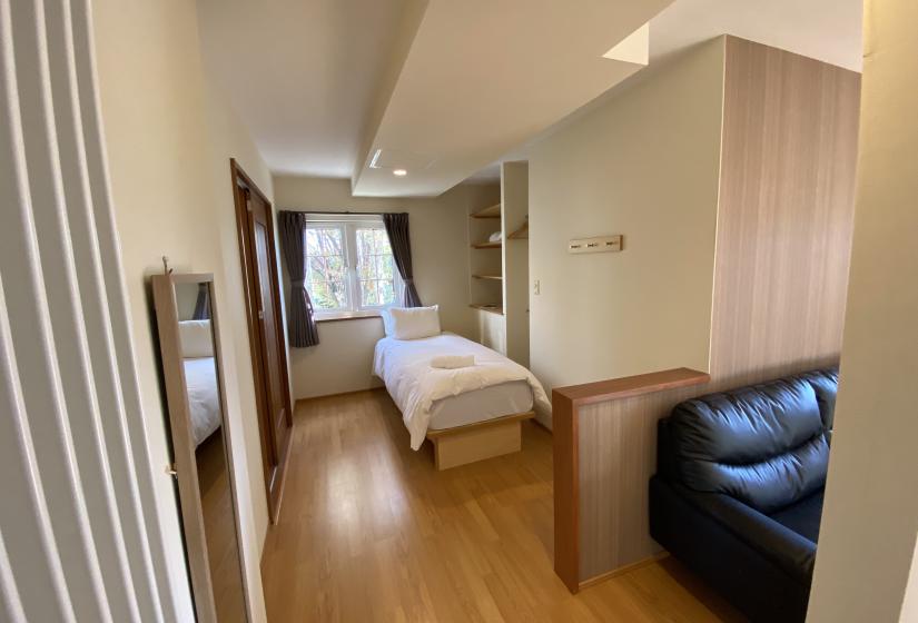 A single bed and window behind