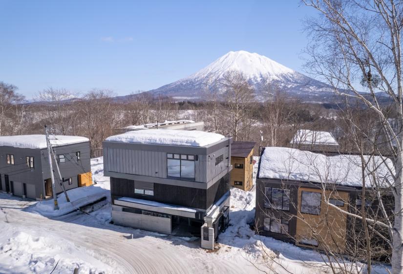 A two story home with Yotei behind