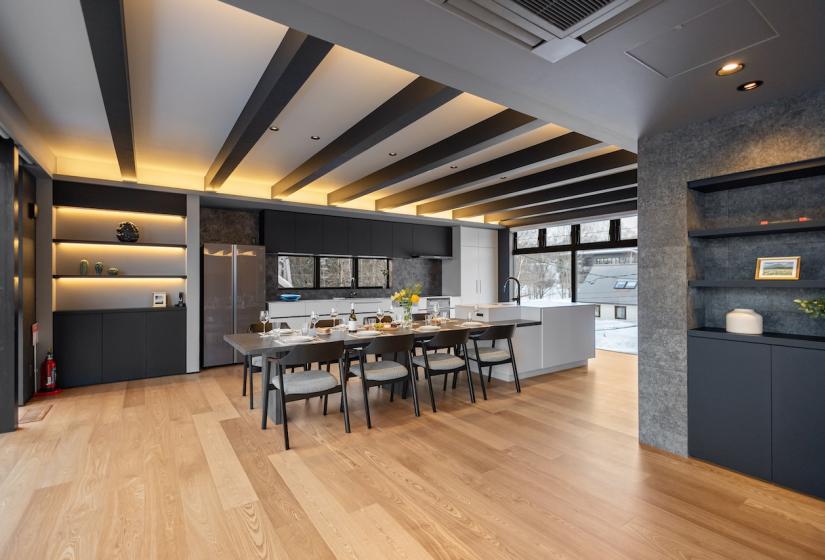 A set dining table in a room with many brown beams